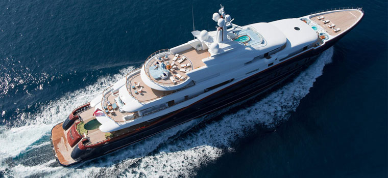 Large superyacht cruising along the Mediterranean coast near Antibes